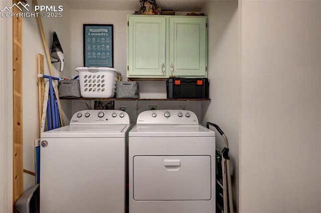 laundry area featuring washing machine and dryer and cabinet space