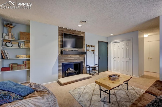 carpeted living room featuring a large fireplace, baseboards, visible vents, a textured ceiling, and recessed lighting