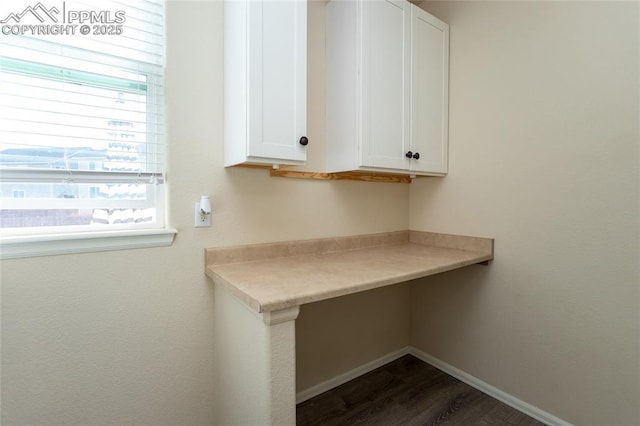 washroom featuring dark wood-style flooring and baseboards