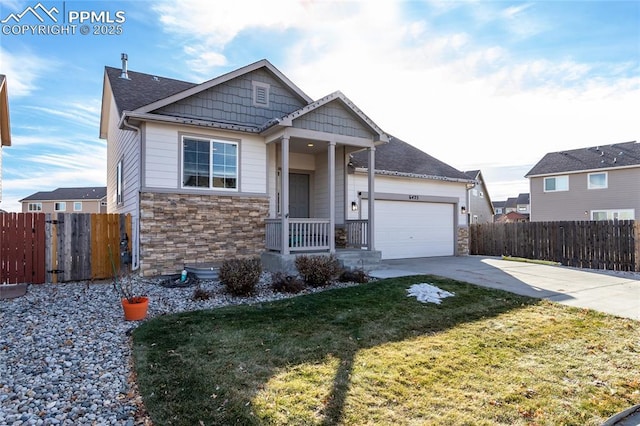 view of front facade featuring a garage, stone siding, fence, and driveway