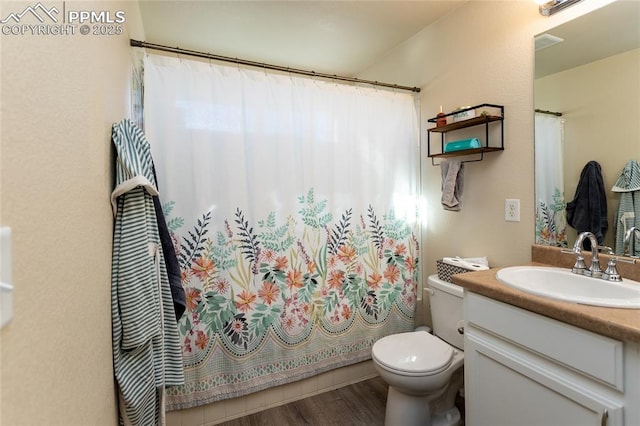 bathroom with wood finished floors, a shower with shower curtain, vanity, and toilet