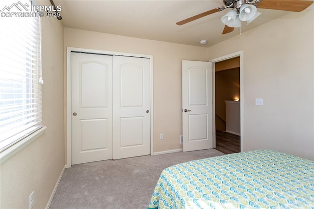 bedroom with ceiling fan, carpet floors, a closet, and baseboards