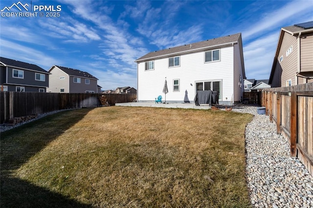 back of house with a fenced backyard, a residential view, a patio, and a yard