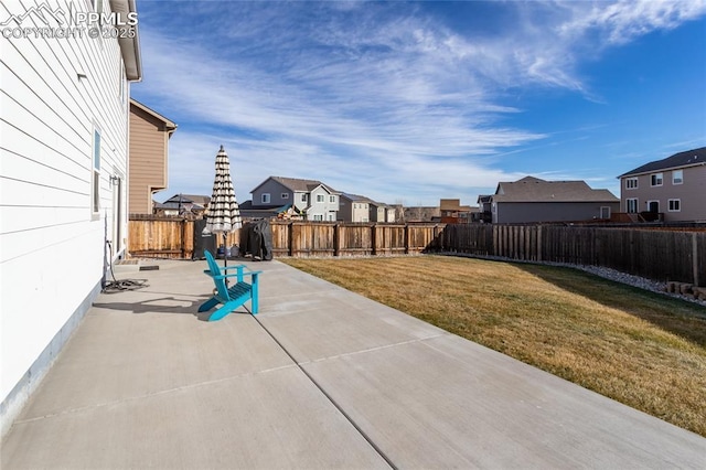 view of patio / terrace with a residential view and a fenced backyard