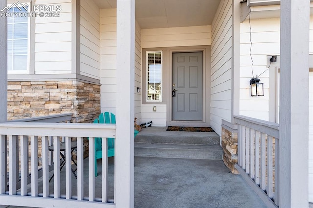 property entrance with stone siding