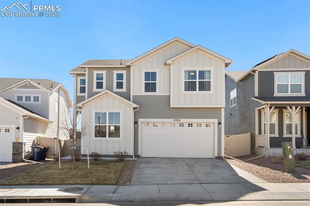 view of front of property featuring a garage, driveway, board and batten siding, and fence