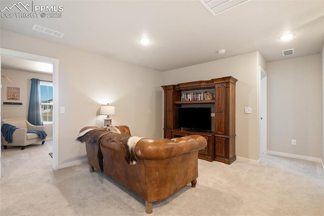 living room with baseboards, visible vents, and light colored carpet