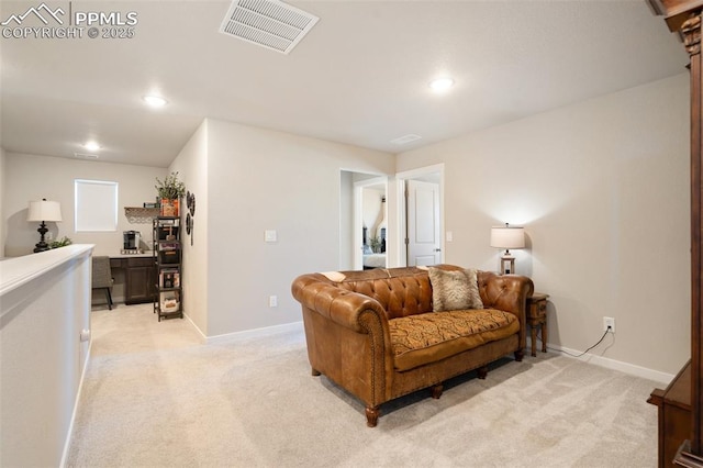 living area with light carpet, baseboards, and visible vents