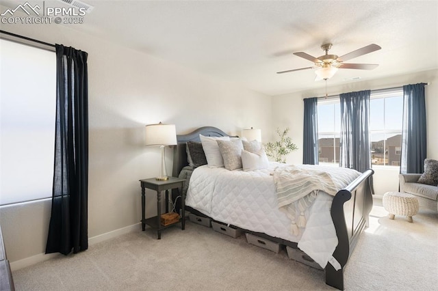 bedroom with light carpet, ceiling fan, and baseboards