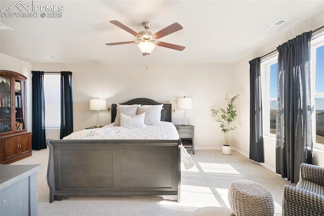 bedroom featuring light carpet, baseboards, visible vents, and ceiling fan