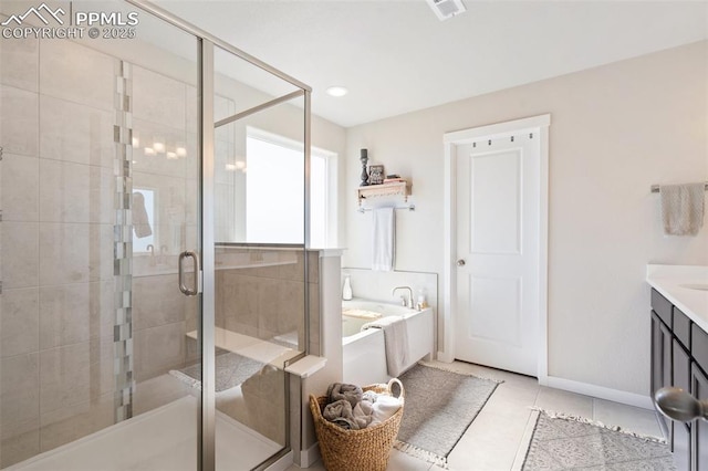 bathroom with tile patterned flooring, a garden tub, vanity, baseboards, and a stall shower