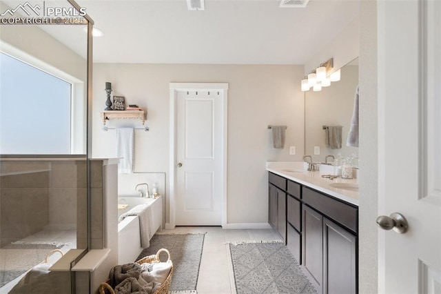 bathroom with a sink, visible vents, a bath, tile patterned floors, and double vanity