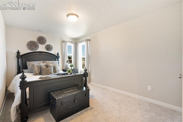 carpeted bedroom featuring visible vents and baseboards