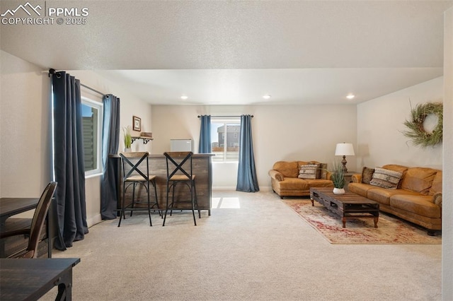 carpeted living room with recessed lighting and a textured ceiling