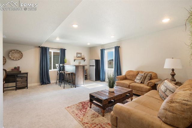 living area with a bar, recessed lighting, baseboards, and light colored carpet