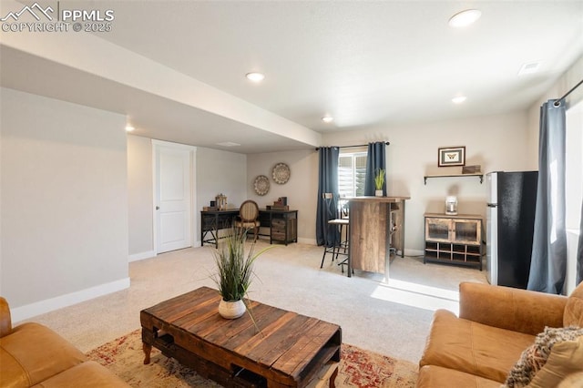 living area with baseboards and recessed lighting