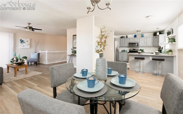 dining room featuring light wood-style flooring and a notable chandelier