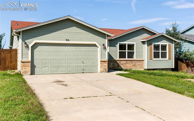 ranch-style house with concrete driveway, brick siding, and fence