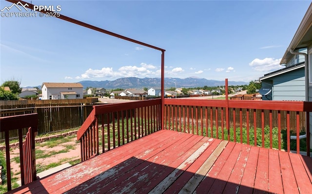 wooden deck featuring a mountain view and fence