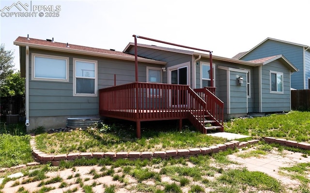 back of house with a deck and fence