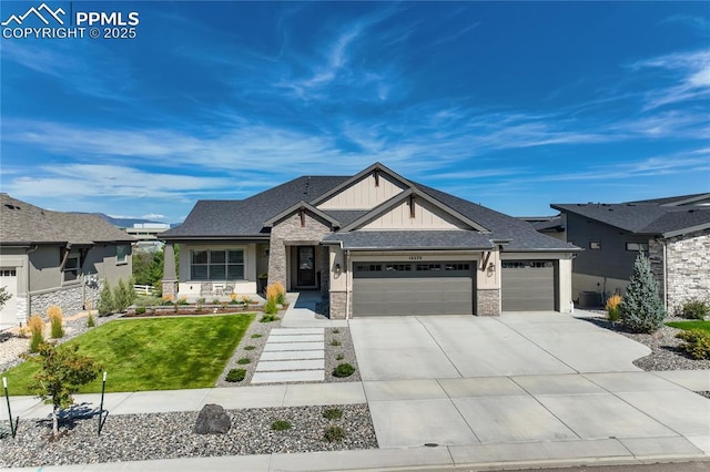 view of front of property featuring board and batten siding, a front yard, a garage, stone siding, and driveway