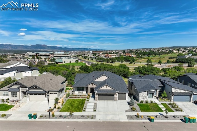 drone / aerial view featuring a residential view and a mountain view