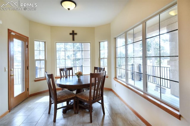 dining area with baseboards and light tile patterned flooring