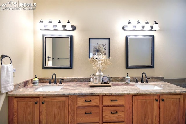 full bathroom with double vanity and a sink