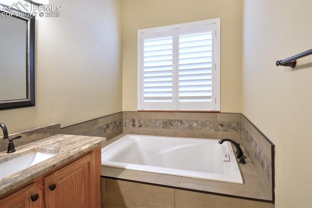 bathroom with vanity and a bath