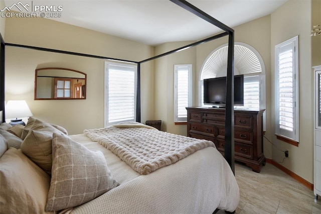 bedroom with multiple windows and baseboards