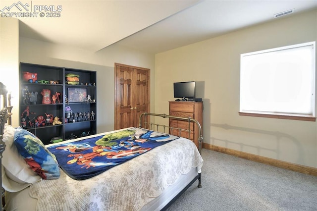 bedroom with carpet floors, visible vents, and baseboards