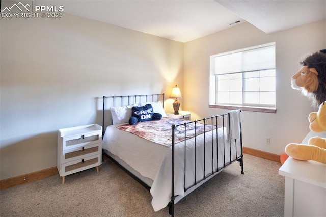 carpeted bedroom featuring visible vents and baseboards