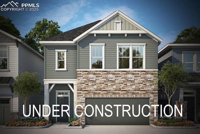 view of front of home featuring an attached garage, stone siding, board and batten siding, and concrete driveway