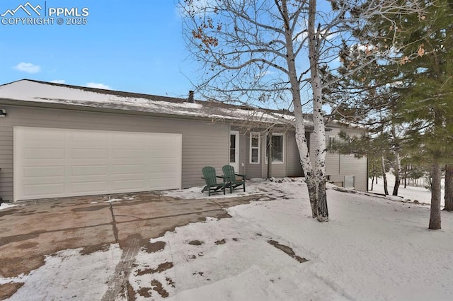 ranch-style house featuring a garage and concrete driveway