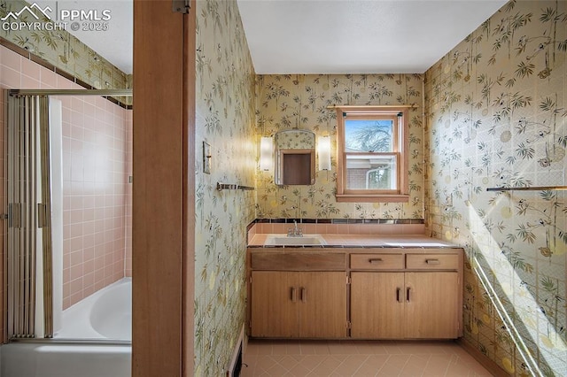 bathroom featuring a tub, vanity, tile patterned flooring, an enclosed shower, and wallpapered walls