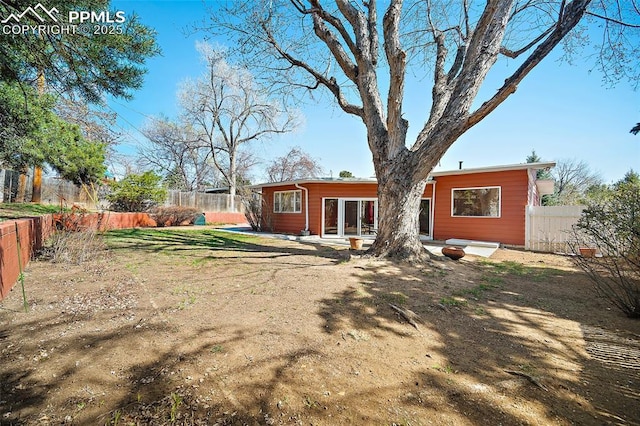 back of house featuring a fenced backyard and a patio