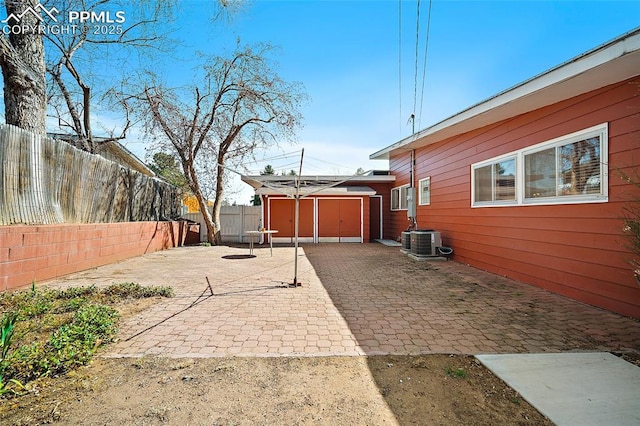 view of side of property featuring central air condition unit, a patio, and a fenced backyard