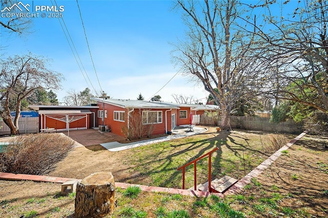 exterior space with central air condition unit, a front yard, and fence