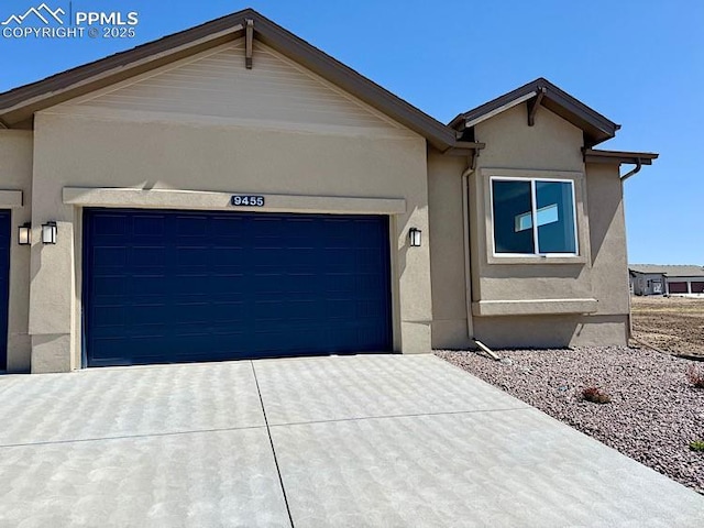 9455 Jollity Pt, Colorado Springs, CO 80924 - ranch-style house with a garage, stucco siding, and concrete driveway