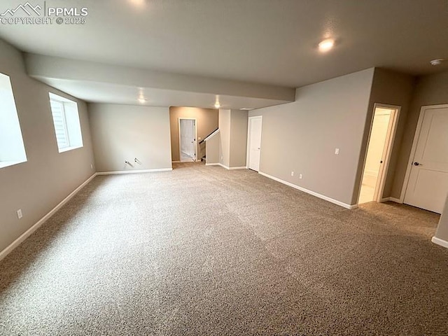9455 Jollity Pt, Colorado Springs, CO 80924 - below grade area featuring baseboards, carpet floors, and stairway