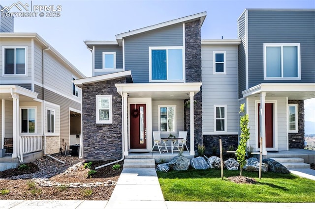 view of front of home featuring stone siding and a porch