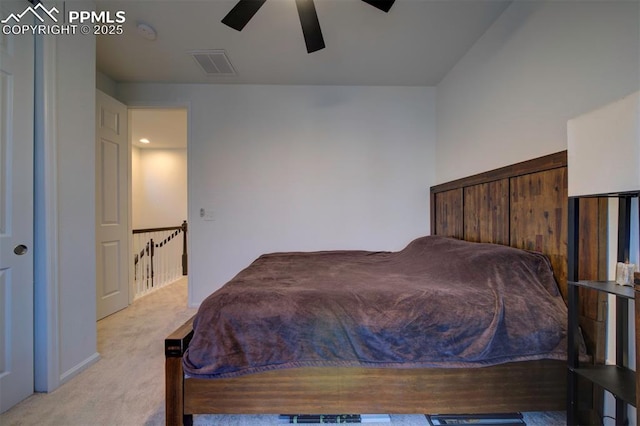 bedroom with ceiling fan, visible vents, and light colored carpet