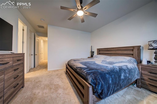 bedroom featuring baseboards, visible vents, a ceiling fan, and light colored carpet