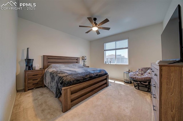 bedroom featuring lofted ceiling, a ceiling fan, and light colored carpet