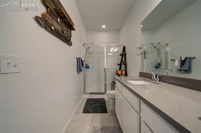 bathroom with toilet, vanity, baseboards, a shower stall, and tile patterned floors