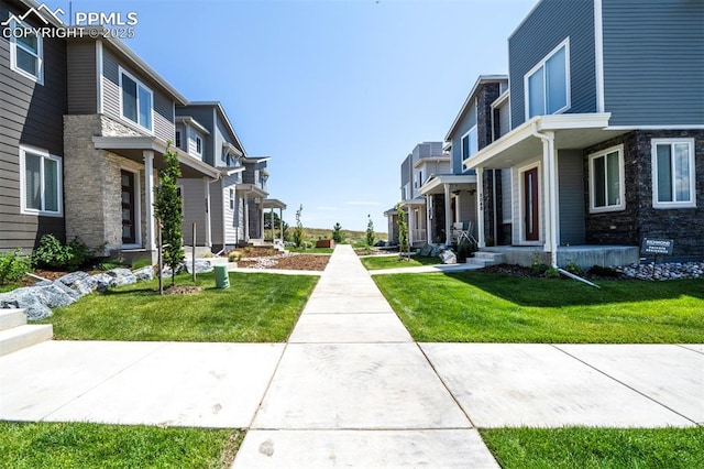 view of community with a residential view and a lawn