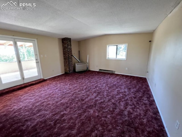 unfurnished living room with carpet floors, baseboard heating, vaulted ceiling, a textured ceiling, and baseboards