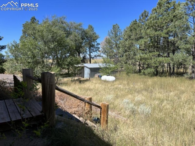 view of yard featuring an outbuilding and a storage shed