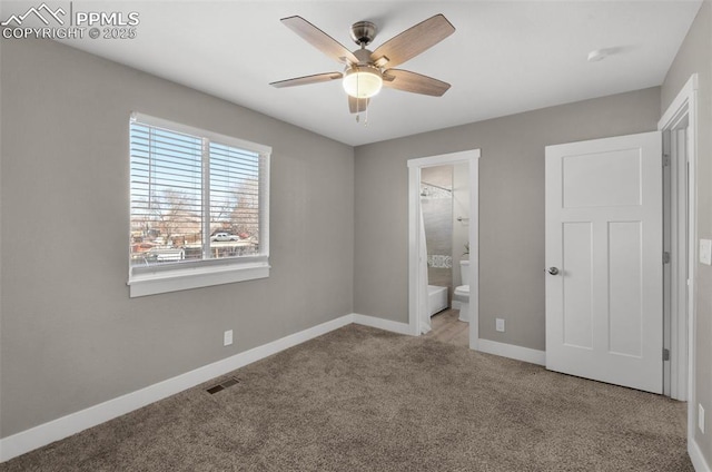 unfurnished bedroom featuring carpet floors, visible vents, ensuite bathroom, ceiling fan, and baseboards