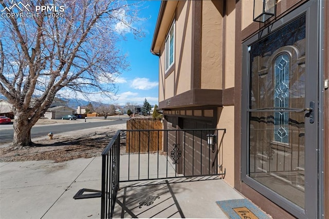 view of exterior entry featuring stucco siding